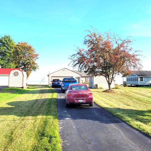 EXTERIOR:  The front of the home, highlighting the long driveway that easily has room for up to 3 vehicles.