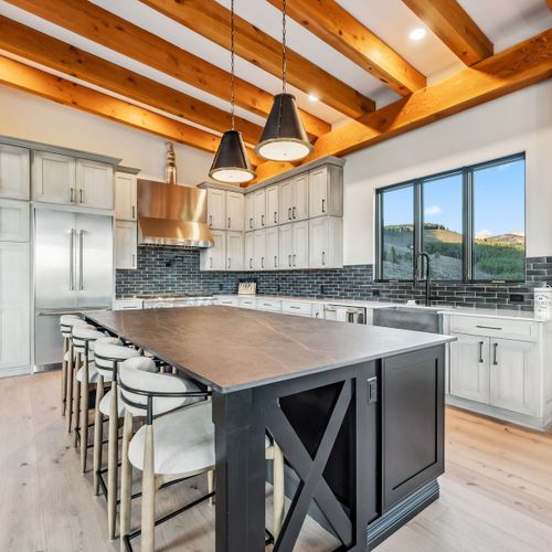 Elegant dining space adjacent to the kitchen, vaulted ceiling above.