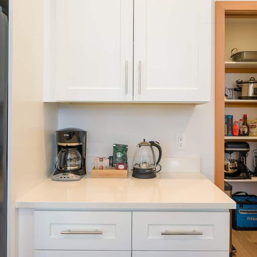 The coffee area offers a drip coffee maker, French press, and pour-over—everything you need for your perfect cup.