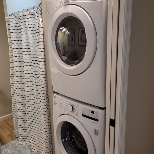 Bathroom #2:  second full bathroom that also serves as the laundry room having a stacked washer and dryer in it.