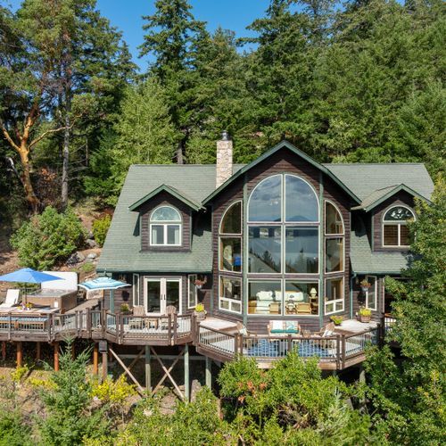 Decks and gardens surround the entire home