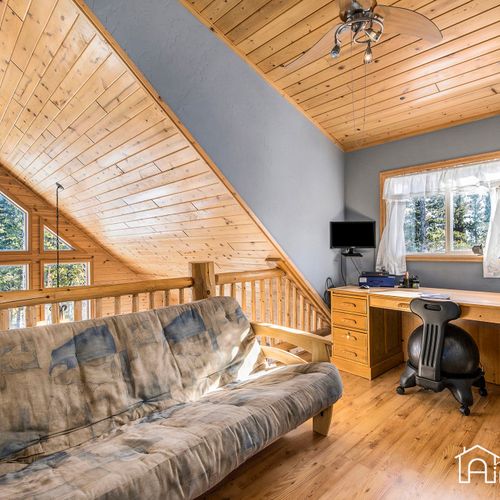 Stay productive  inour a-frame loft office with a spacious desk with an alpine view.