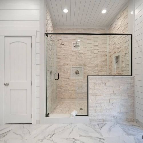 Walk-in shower with multiple shower heads.