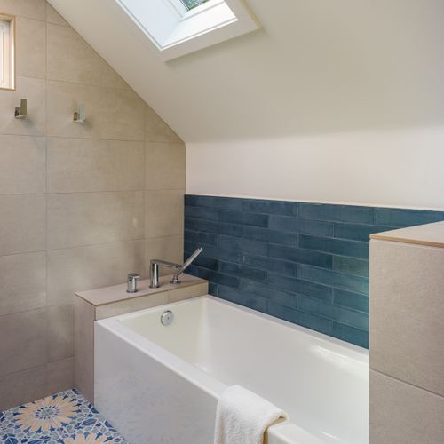 This amazing bathroom includes a soaker tub with a skylight to the towering trees outdoors.