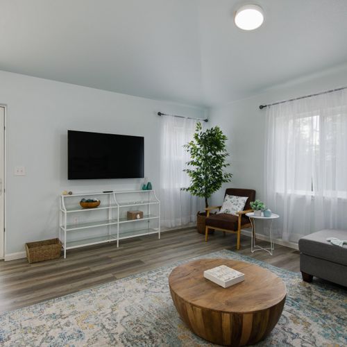 The open and bright living space flows effortlessly into the kitchen and back patio.
