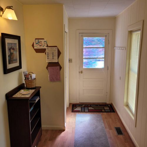 LIVING ROOM:  Features a loveseat, comfy chairs, live-streaming television with Roku, and a ceiling fan.