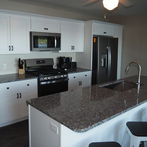 Kitchen:  newly remodeled and features a gas stove and stovetop, refrigerator, microwave oven, dishwasher, keurig coffee maker, toaster, island with sink, barstools, lots of counter space and cabinets, and a good supply of cooking & dining utensils.
