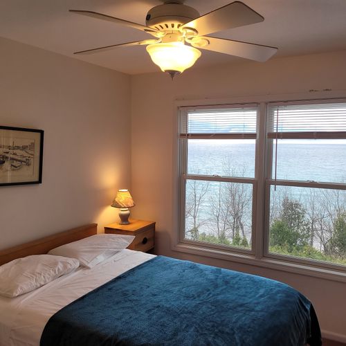 Bedroom #3 (upper level):  features a full-size bed, ceiling fan, closet, and great views of lake michigan.