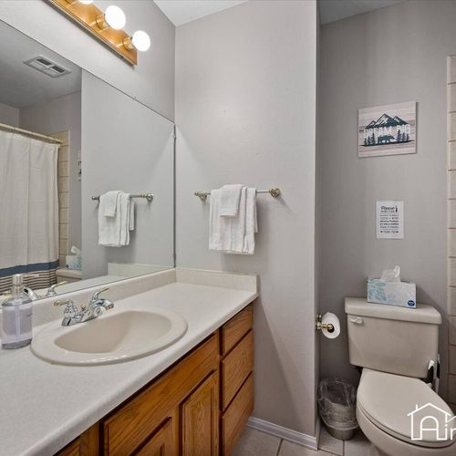 - full bath with tub and shower combo, large mirror, and classic wood vanity design
- bright lights and neutral tones make the space functional and family friendly
- includes all essentials plus plenty of counter space for guest toiletries