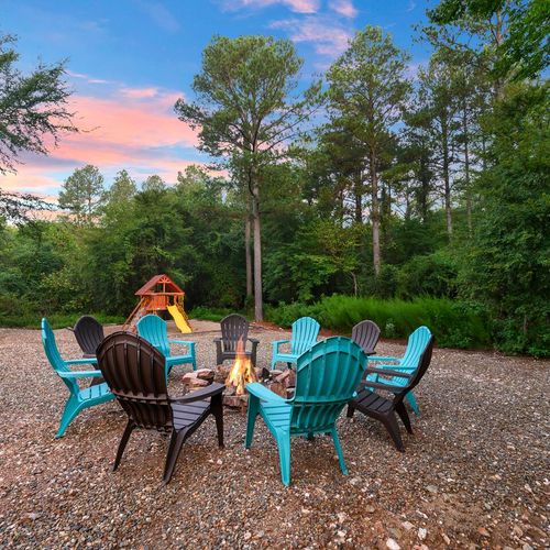 A fire pit with chairs.