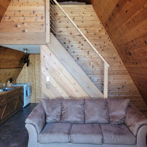 Living room:  features a sofa, futon, and a large television with cable television.
