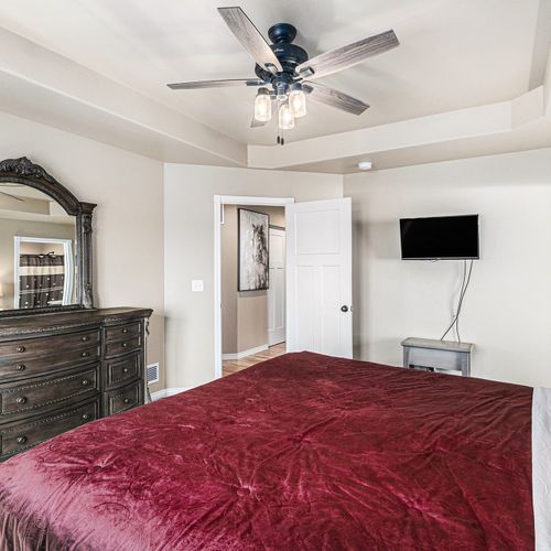 With a tv and plush sofa in the master bedroom, you can indulge in comfort and entertainment at any time.