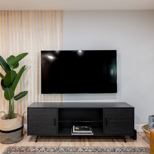 Relax in the living room with our leather sofa and 65-inch smart tv.