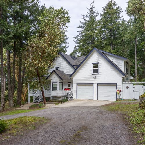 The driveway is a circular drive with parking for two to three small vehicles.  There is parking below the house for an extra car.