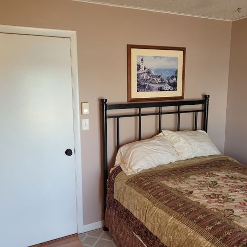 Bedroom #2 (first floor):  features a full-size bed, two closets, television, private entrance, and a great view of crystal lake!