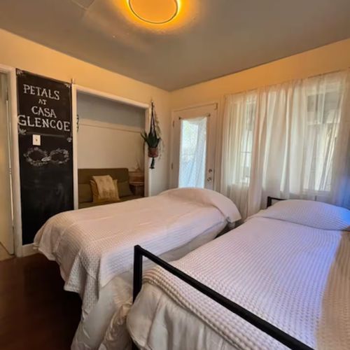 The third room features two plush beds designed for ultimate comfort.