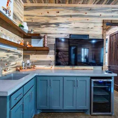 Closer look at the wet bar equipped with counter space, smart tv and mini fridge