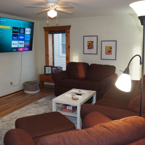 Living room:  super comfy with a sofa, loveseat, plush chair, coffee table, ceiling fan, and huge 55" live-streaming television with roku.