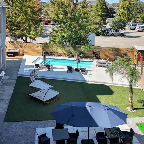 Bird’s-eye view of our spacious courtyard, complete with a sparkling pool, lounge area, and fun games for guests to enjoy under the New Orleans sun.