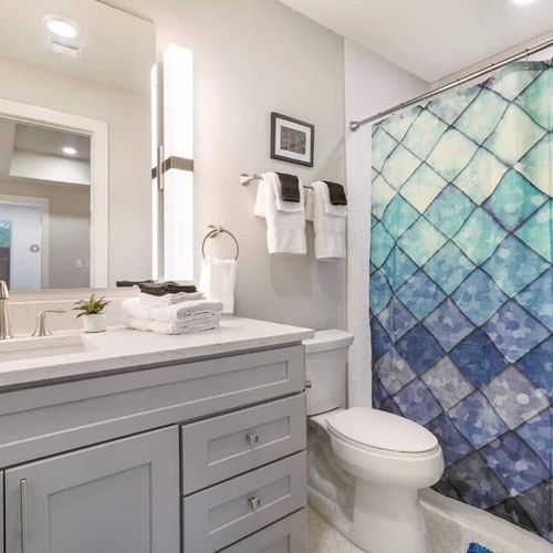 Clean, well-lit bathroom w/ sink & tub — everything you need to refresh.