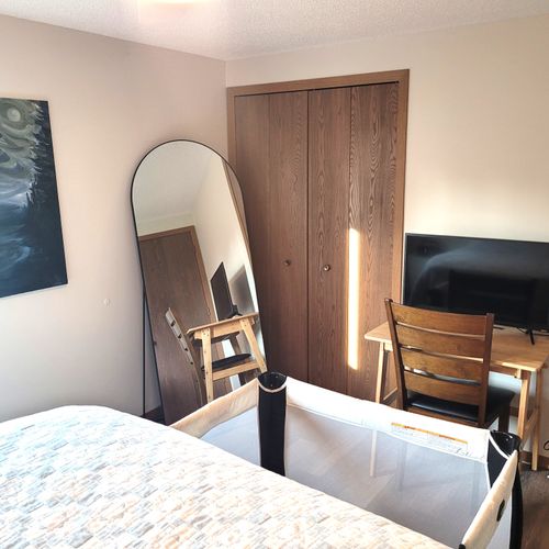 BEDROOM #2:  Features a queen-size bed, crib, ceiling fan, closet, nightstands, lamp, mirror, and a private desk and television