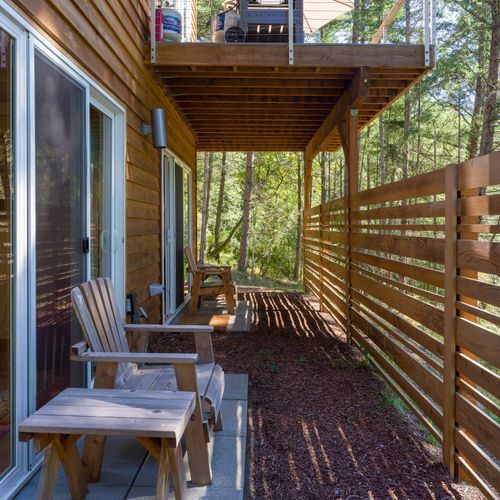 Custom privacy screening creates a quiet space for reading and relaxing outdoors.
