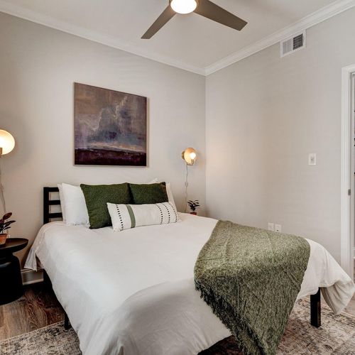 Bright queen bedroom w/ clean, classic style for a restful night's sleep.