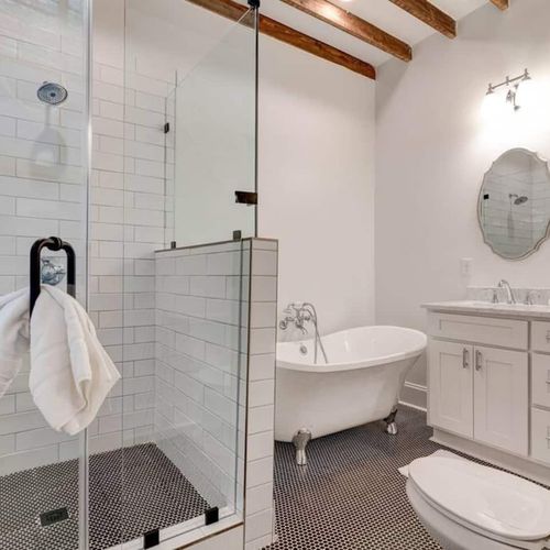 Glass-enclosed shower w/ sleek tile — a refreshing start to any morning.