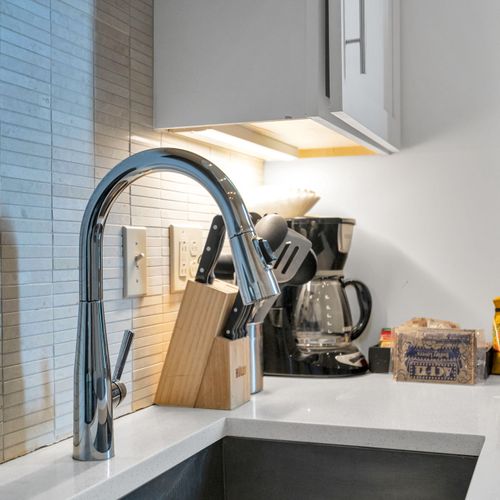 Enjoy a deep sink, under-cabinet lighting, and everything you need—from coffee to cookware—for a convenient, comfy stay.