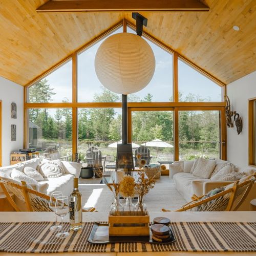 the open concept kitchen and beautiful main living room that looks out over the deck