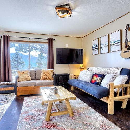 - floor to ceiling windows fill the room with sunlight and stunning scenery
- lounge on the soft futon or fluffy loveseat after a day of mountain adventures
- rustic artwork, wood furniture, and guitar decor add charm and character