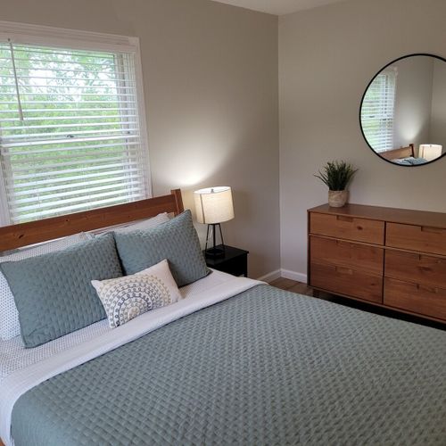 Bedroom #2:  bedroom #2 features a queen-size bed, ceiling fan, dresser, matching nightstands with lamps, and a closet.