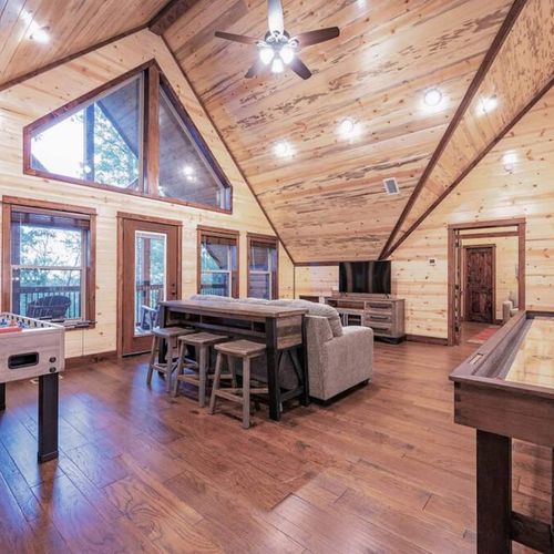 The loft features a foosball table, a sleeper sofa and shuffleboard table.