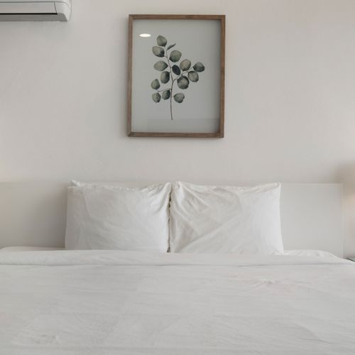 Pure comfort in this inviting white bedroom. Designed for ultimate relaxation and a peaceful sleep.