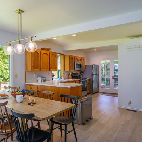 Open kitchen with counter space, seating and a dedicated coffee bar