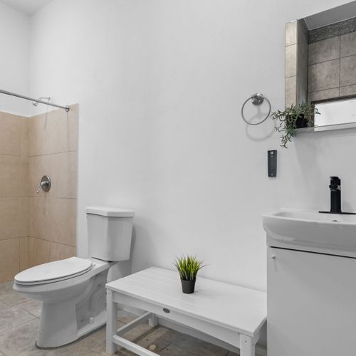 Refresh yourself in this pristine bathroom where contemporary aesthetics meet functionality.