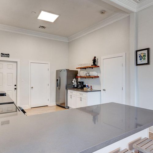 Open kitchen w/ stainless fridge & plenty of cabinet space — everything you need to cook with ease.