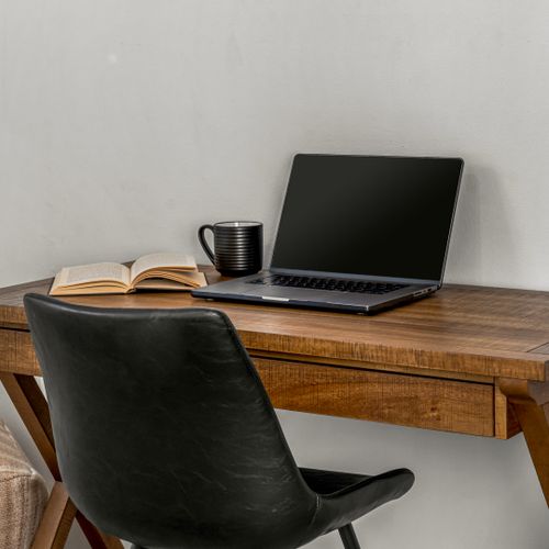 A streamlined wooden desk offers a quiet spot to catch up or plan your day.