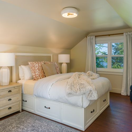 Head upstairs, The Waterview bedroom is the largest with a reading chair and plenty of space to unpack. Furnished with two armoires and nightstands with drawers.