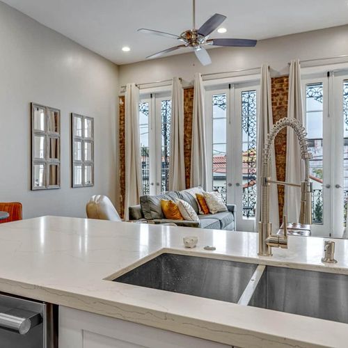 Sunlit kitchen & bar area w/ a sink island — perfect for casual mornings.
