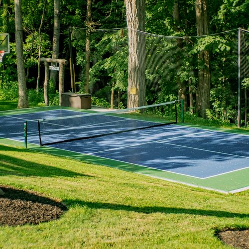 Looking from the pool deck towards the court and entrance to private hiking trail.