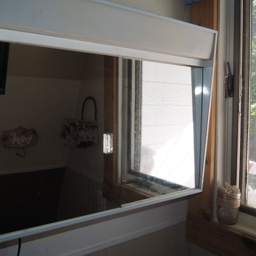 Bathroom:  small, but full bathroom, with entrance from the living room. Includes sink, mirror, toilet, and shower.