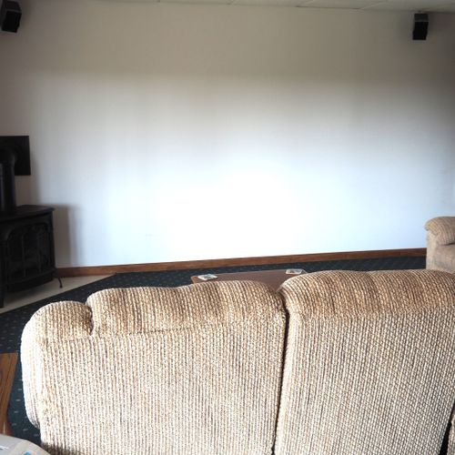 Living room #2 (lower level):  features a sofa and loveseat, bar area, and 3 single beds.
