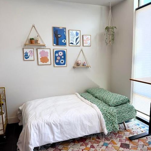 Stylish futon bed, neatly made and ready to offer relaxed comfort for two guests