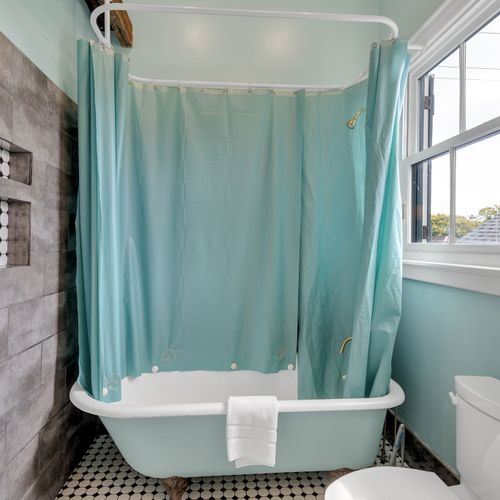 Bright space w/ teal curtains & a light-filled, cheerful energy.