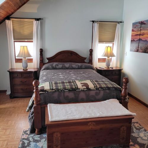 Bedroom #2 (second floor):  very large bedroom features a queen-size bed, walk-out deck, chair, 2 nightstands, 2 lamps, 2 dressers, ceiling fan, television, and private en suite full bathroom