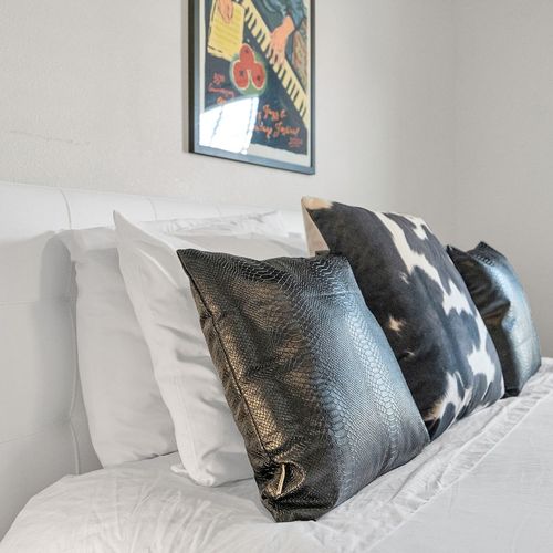 Third bedroom w/ a plush bed & layered pillows for a hotel-like feel.