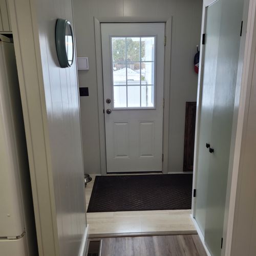 Bathroom #2:  cute little half-bathroom with toilet, sink, vanity, and mirror located near the rear door out to the deck.