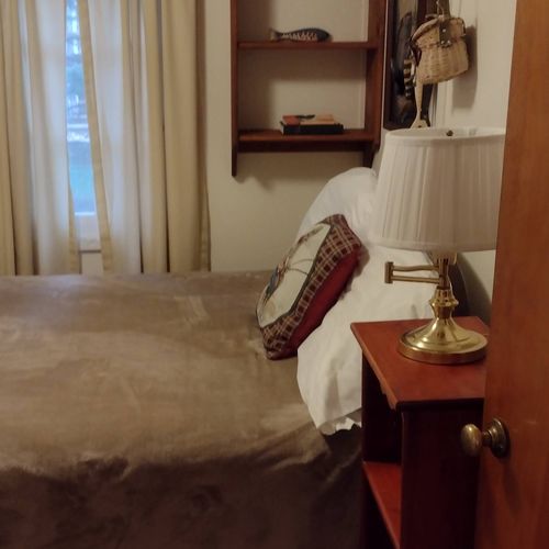 Bedroom #2:  features a full-size bed, nightstand, lamp, dresser. And closet.