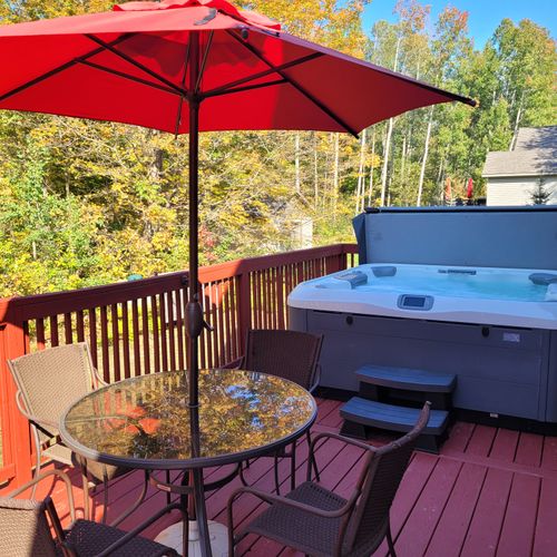 OVERVIEW:   The new hot tub and outdoor dining furniture on the backyard deck